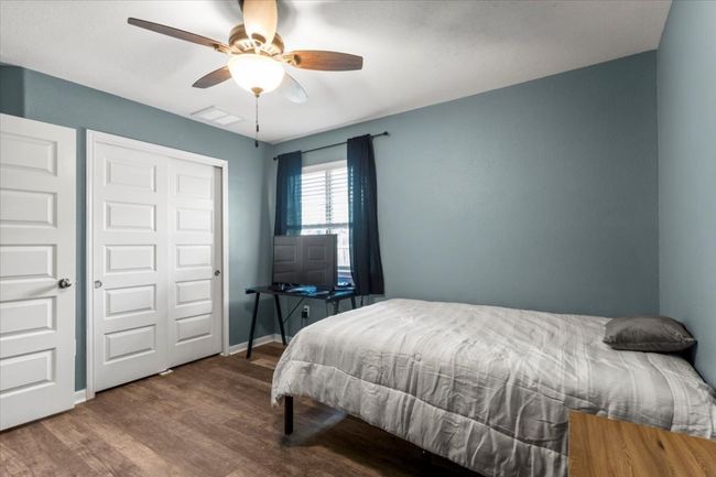 Bedroom with wood finished floors, ceiling fan, baseboards, and a closet | Image 21
