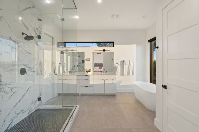 Primary bath with soaking tub looking out on Apache Shores Lake | Image 20