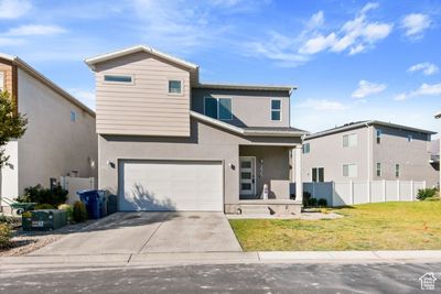 View of front property with a garage and a front lawn | Image 1