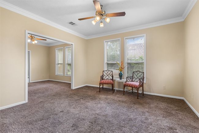 Living area featuring a ceiling fan | Image 6