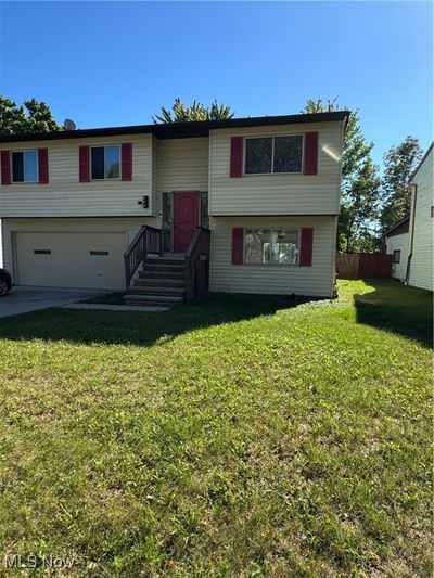 Split foyer home with a front yard and a garage | Image 1