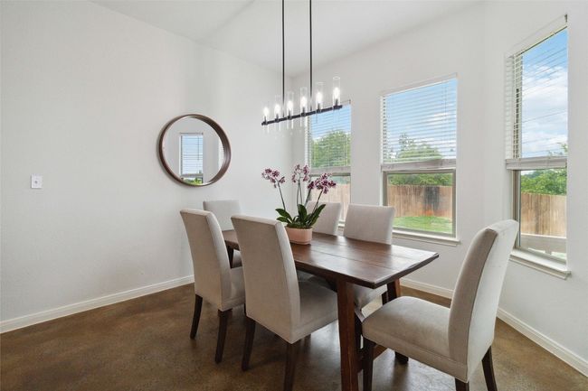 Dining space with baseboards and a chandelier | Image 10