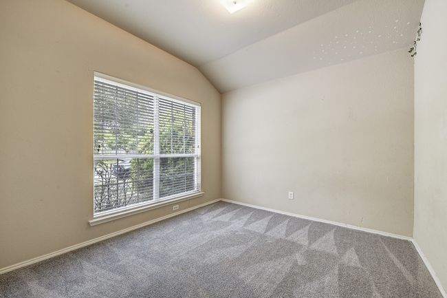 Carpeted spare room with vaulted ceiling and baseboards | Image 5