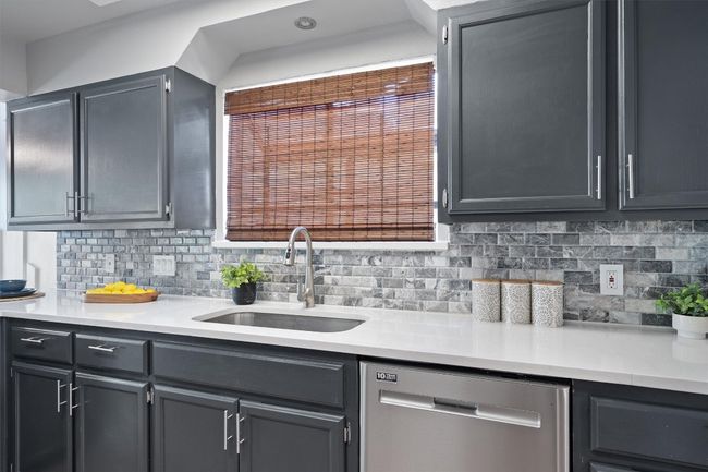 Kitchen with dishwasher, light countertops, and tasteful backsplash | Image 12