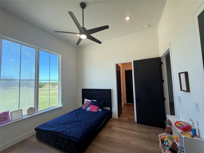 Bedroom featuring wood finished floors, a ceiling fan, and recessed lighting | Image 12