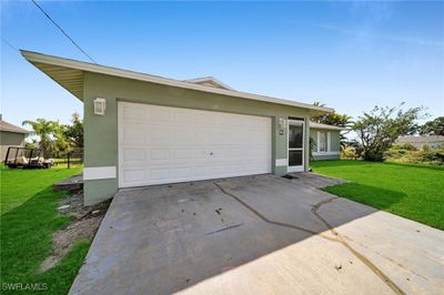 View of front of house featuring a front yard and a garage | Image 2