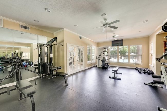 Gym featuring ornamental molding, a ceiling fan, recessed lighting, a textured ceiling, and french doors | Image 28