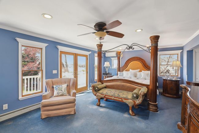 Full bath with radiator heating unit, wood finished floors, ornamental molding, vanity, and toilet | Image 33
