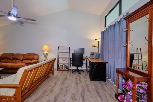 Office space with ceiling fan, vaulted ceiling, and wood finished floors | Image 8