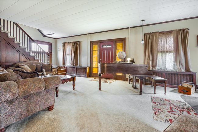 Carpeted living area with ornamental molding and stairway | Image 6