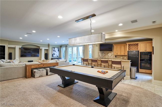 Family room with space for billiards, and close to the bar/kitchen for the lower level. | Image 32