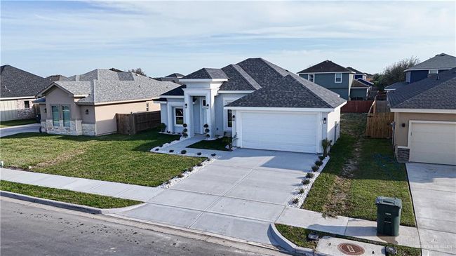 View of front of home with a residential view, fence, a front lawn, and stucco siding | Image 4