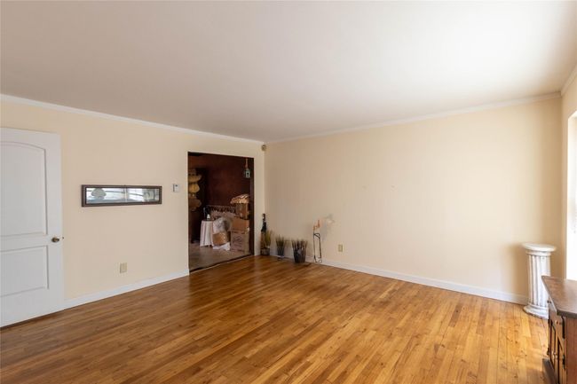 Unfurnished room featuring light wood finished floors, baseboards, and ornamental molding | Image 17