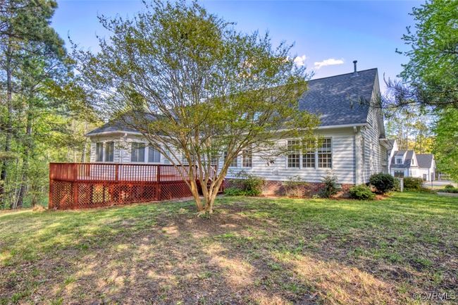 Rear view of house with a lawn, roof with shingles, and a deck | Image 16
