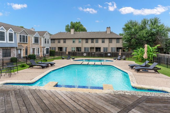 Community pool with a patio area, a residential view, and a deck | Image 25