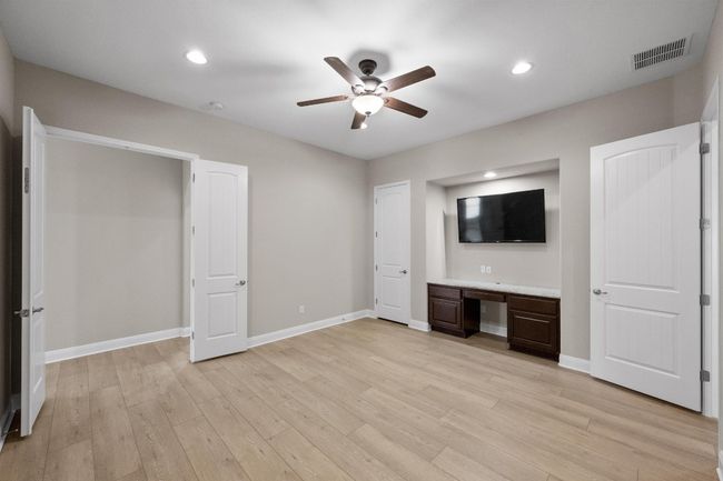 Unfurnished bedroom with light wood-style flooring, built in study area, recessed lighting, and a ceiling fan | Image 18
