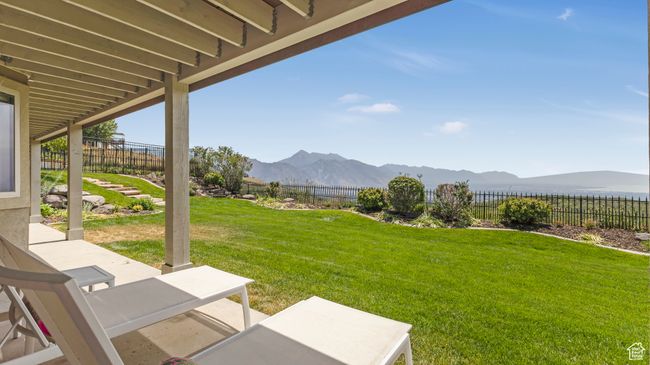 Fenced backyard with a mountain view and a patio | Image 47