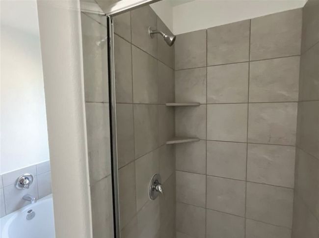 Full bathroom featuring a shower stall and a bath | Image 21