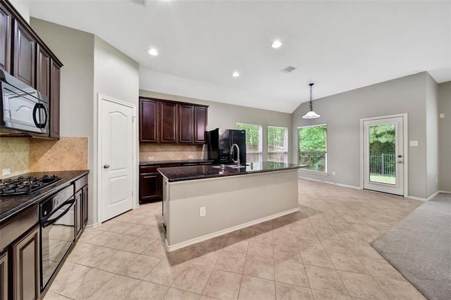 You’ll love the stunning kitchen with a large granite island. | Image 8