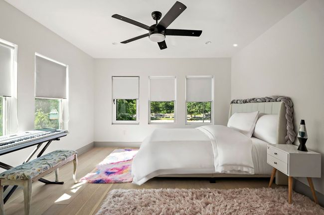 Bedroom with baseboards, a ceiling fan, wood finished floors, and multiple windows | Image 24