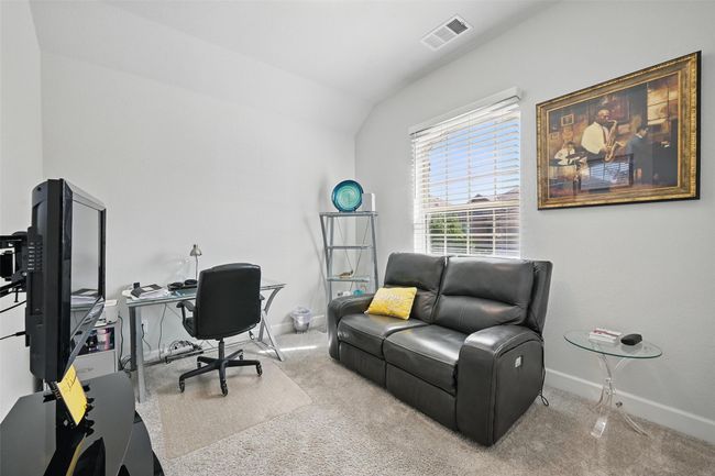 Carpeted home office with baseboards and lofted ceiling | Image 19