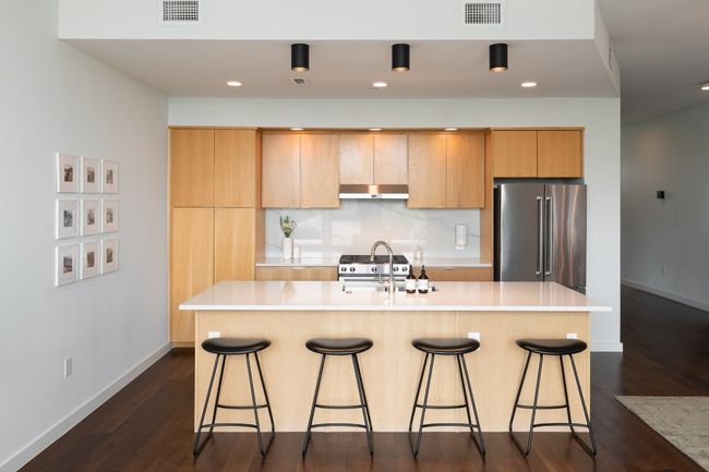 Kitchen featuring visible vents, a sink, under cabinet range hood, and high quality fridge | Image 4