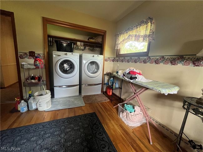 Washroom featuring washer and clothes dryer and hardwood / wood-style floors | Image 14