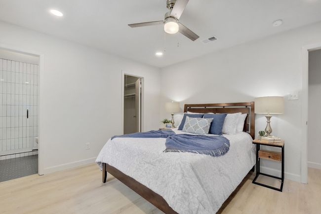 The primary suite features a large walk-in closet, recessed lighting and a newly remodeled ensuite bathroom. | Image 12