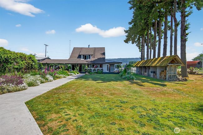 Walkway from sandy beach to house. This property abounds with flowers and exotic plants. | Image 11