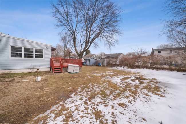 Yard layered in snow with a wooden deck | Image 38