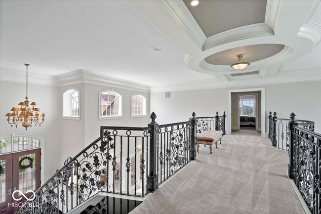 The upstairs catwalk overlooks the entry, dining room and formal living room. This hallway splits bedroom #2 & #3. | Image 36