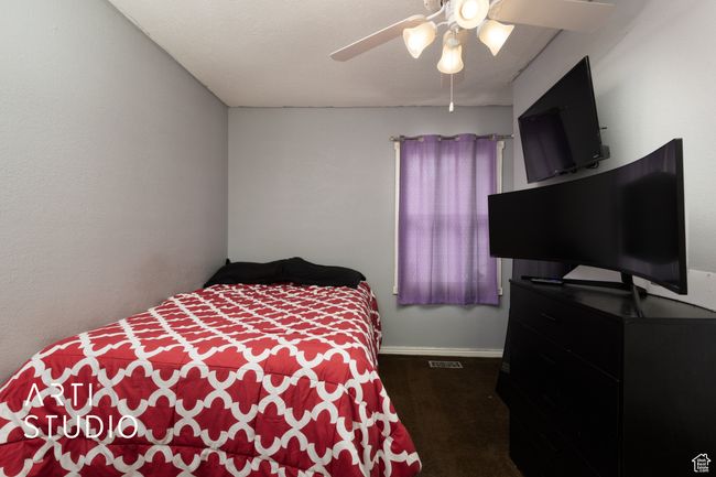 Carpeted bedroom with a ceiling fan and baseboards | Image 45