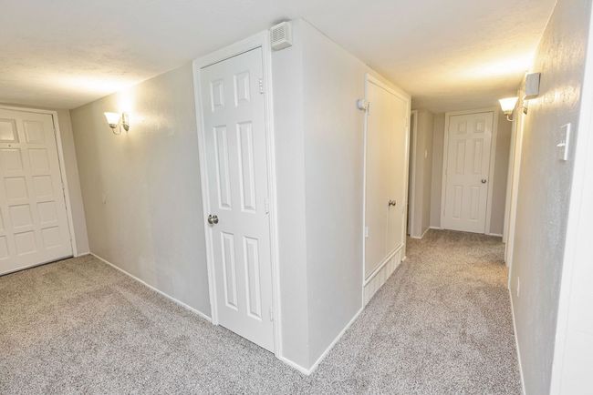 Hall featuring carpet, baseboards, and a textured ceiling | Image 16