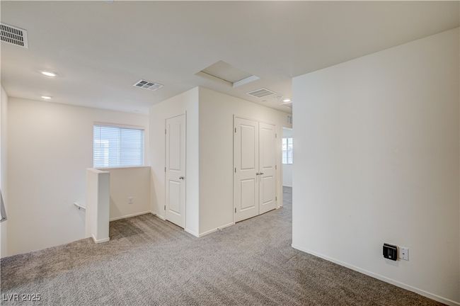 Carpeted empty room featuring healthy amount of natural light, attic access, and recessed lighting | Image 9