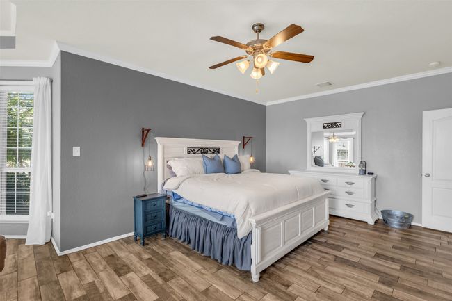 Bedroom with ceiling fan, ornamental molding, and hardwood / wood-style floors | Image 6