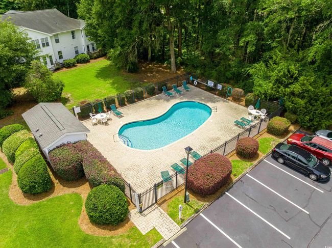 Community pool featuring a gate and a patio area | Image 33