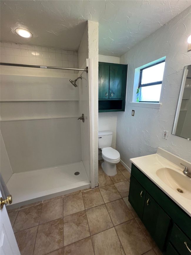 Bathroom with vanity and a stall shower | Image 8