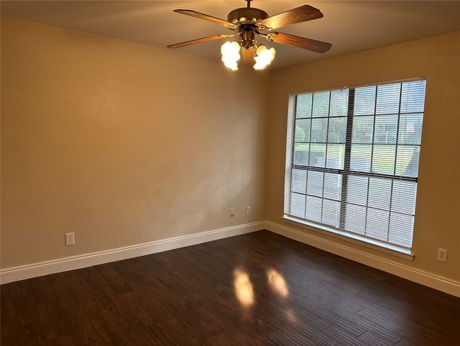 Spare room with ceiling fan and dark wood-style floors | Image 14