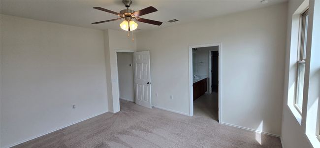 Master bedroom featuring carpet flooring, ceiling fan, and connected bathroom | Image 17