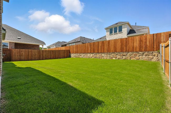 View of fenced backyard | Image 34
