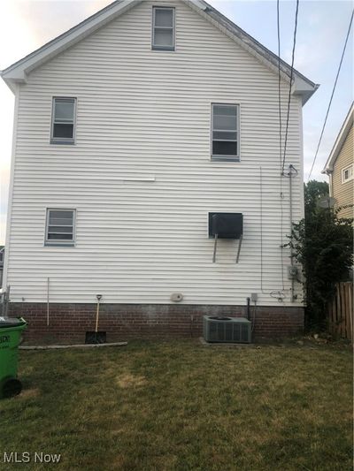 View of home's exterior with central AC and a lawn | Image 2