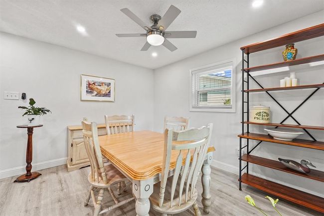 Adjacent dining space with elegant lighting and easy access to the kitchen. | Image 8