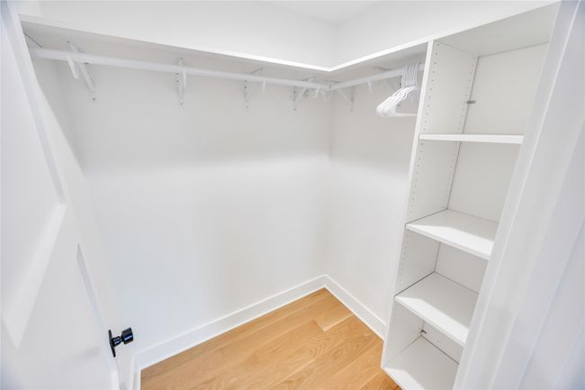 Spacious closet featuring light wood finished floors | Image 33