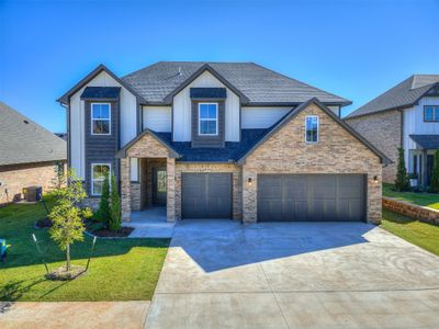 Craftsman house with a garage, central AC unit, and a front lawn | Image 2