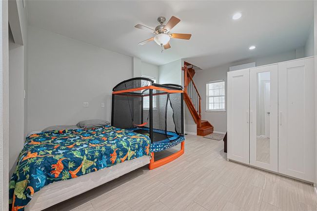 Ample storage and wooden stairs lead to an upper level. | Image 26