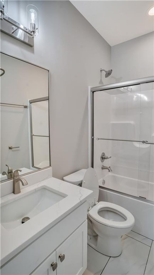 Full bath featuring shower / tub combination, toilet, and vanity | Image 19