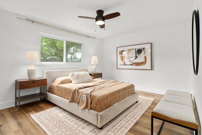 Bedroom with wood finished floors and ceiling fan | Image 10