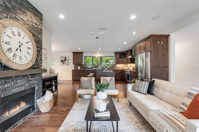 The modern designer fireplace is nestled in a striking floor-to- ceiling hearth providing for a warm and welcoming focal centerpiece for your spacious living room. | Image 13