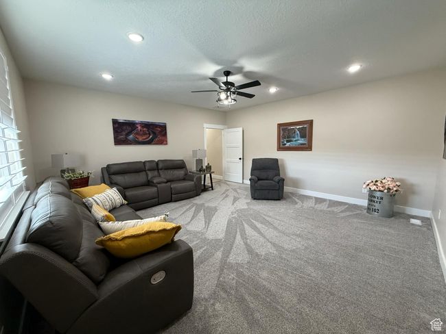 Living room with baseboards, carpet flooring, recessed lighting, and a ceiling fan | Image 52