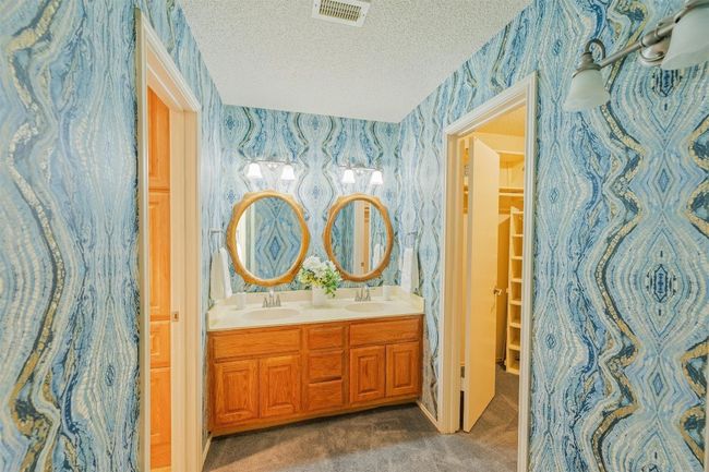 Primary bathroom with double sinks, great lighting, and lots of storage. | Image 15